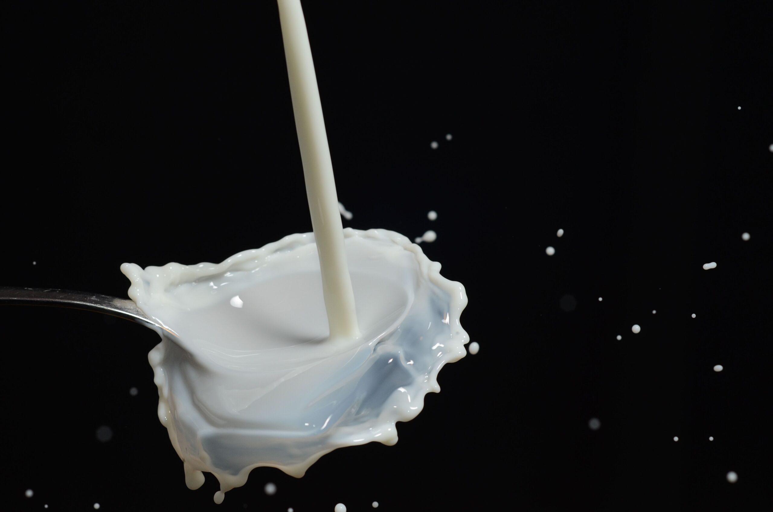 Splash of milk in mid-air, the cost of which is compared to drinking coffee black
