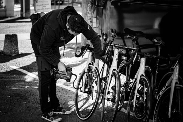 Man examining road bicycles outdoors, relevant to the cycle to work scheme in Scotland