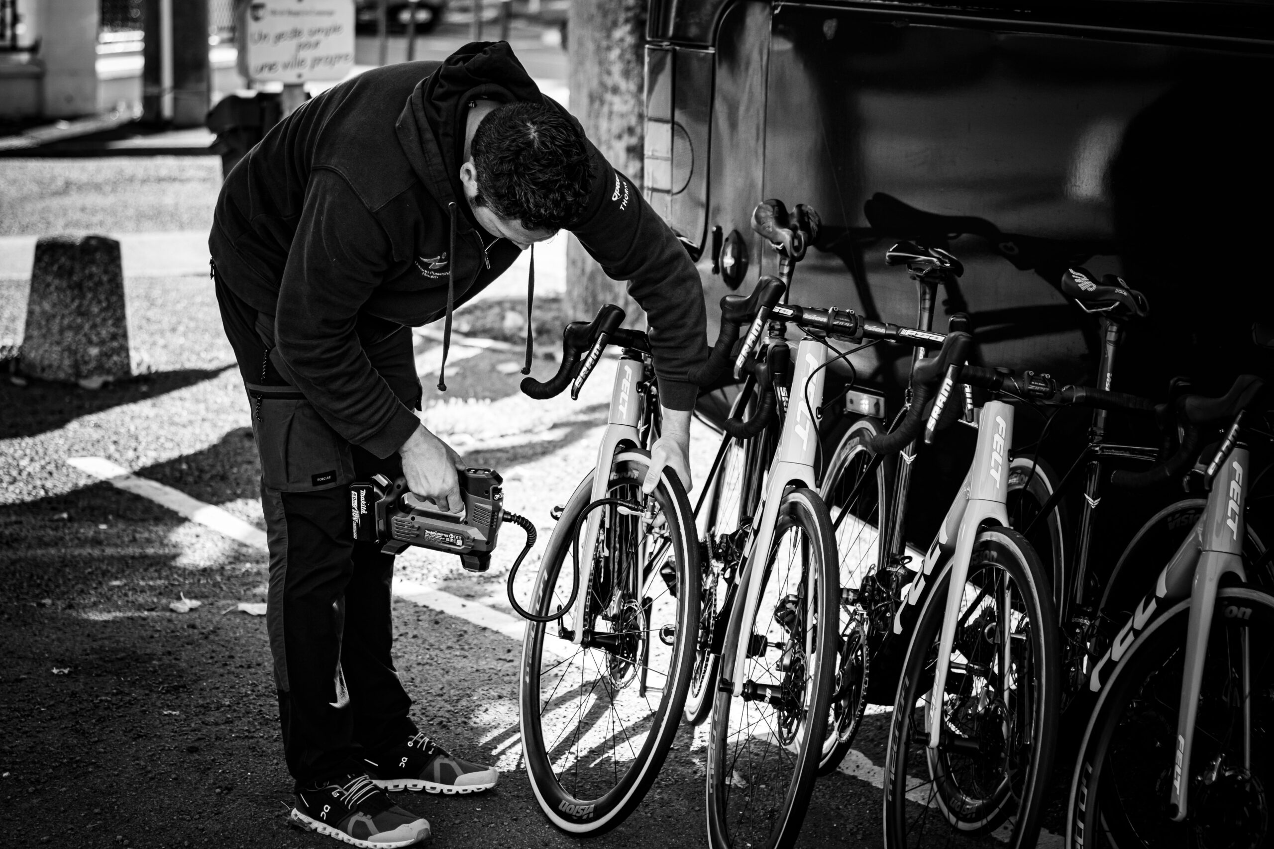 Man examining road bicycles outdoors, relevant to the cycle to work scheme in Scotland