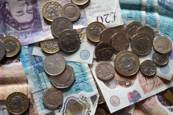 Close-up of British coins and banknotes, showcasing different denominations for financial concepts.